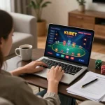 Player enjoying a kubet online poker game on a laptop in a cozy living room with strategy notes.