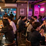 Experience the exciting atmosphere of 상봉동 한국관나이트, with friends enjoying drinks and snacks in a vibrant nightlife setting.